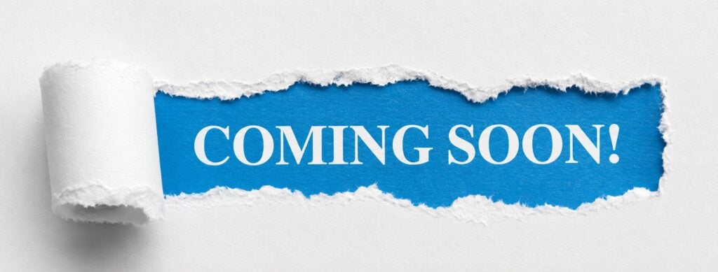 White paper torn open revealing a blue background with the words "COMING SOON!" in bold white capital letters.
