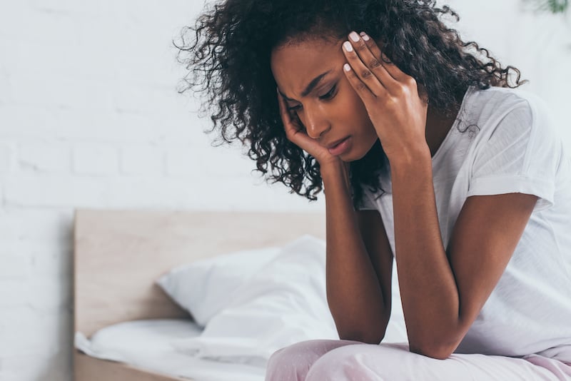 PRP therapy TMJ Headaches page showing a woman holding her temples with migraine pain